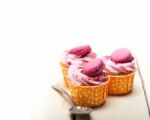 Pink Berry Cream Cupcake With Macaroon On Top Stock Photo