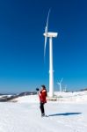 Young Woman Is A Happiness With Camera In Winter Of Sky And Winter Road With Snow And Red Dress Stock Photo