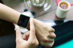 Hand Using Watch On Top View Stock Photo