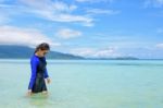 Asian Woman Walking In The Sea At Travel To Koh Lipe Island Stock Photo