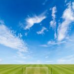 Soccer Field With Blue Sky Background Stock Photo