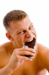 Muscular Man Eating Chocolate Stock Photo