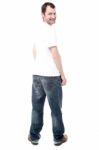 Handsome Man In Jeans Standing Back Stock Photo