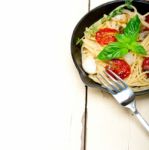 Spaghetti Pasta With Baked Cherry Tomatoes And Basil Stock Photo