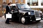 Businessman Interacting With Taxi Driver Stock Photo