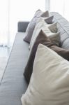 Row Of Pillows On Modern Grey Sofa Stock Photo