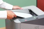 Man Fixing Paper Into Printer Stock Photo