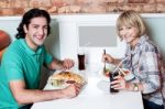 Young Smiling Couple Enjoying Lunch Stock Photo