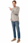 Casual Young Man Pointing Away Stock Photo