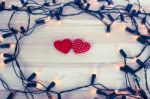 Garland Lights With Red Hearts Shape On Wooden Background Stock Photo