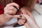 Girl Puts A Nail Polish On Her Client Stock Photo