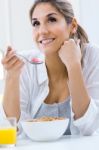 Woman Eating Cereals In The Morning Stock Photo