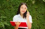 Thai Adult Student University Beautiful Girl Reading Red Book Stock Photo