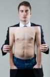 Businessman In Black Suit Holding A Photo Of A Naked Male Torso Stock Photo