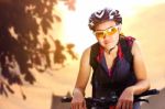 Female Cyclist In Sportswear Riding Bicycle Stock Photo