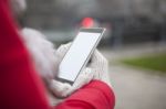 Mobile Phone In Hands With Glowes, Cold Weather Stock Photo