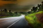 Asphalt Road Run Into The Mountain In Morning Light With Little Stock Photo