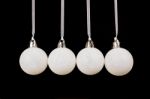 White Christmas Balls Hanging In A Row On Black Background Stock Photo