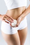 Pretty Young Woman Applying Body Cream. Isolated On Gray Backgro Stock Photo