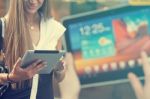 Young Woman With Tablet Computer Walking On Street Stock Photo