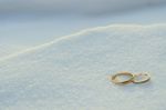 Wedding Rings In The Snow Stock Photo