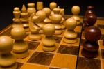 Light And Dark Wooden Chess Pieces On Chess Table Stock Photo