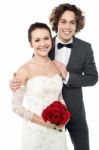 Excited Groom Embracing Beautiful Bride Stock Photo