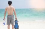 Vacation Backside Of Man Holding Snorkeling Gear On Tropical On Stock Photo