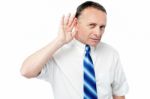 Businessman Trying To Listen Something Stock Photo