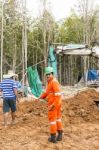 Excavator And Workers Stock Photo