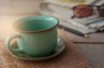 Cup And Stationery On Desk Stock Photo