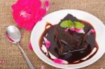 Chocolate Brownie On Plate With Rose Petals Stock Photo