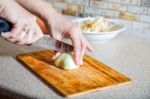 Woman Cuts Onion Stock Photo