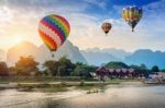 Hot Air Balloon Over Nam Song River At Sunset In Vang Vieng, Laos Stock Photo