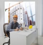 Architect Engineer Working In Office Room Against Building Const Stock Photo