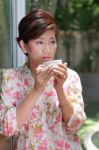 Young Woman Drinking Beverage From White Ceramic Cup Stock Photo