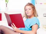 Woman Reading Book At Home Stock Photo