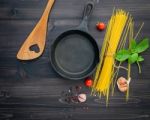 The Thin Spaghetti On Black Wooden Background. Yellow Italian Pa Stock Photo