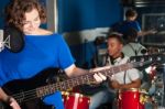 Woman Playing Guitar In Recording Studio Stock Photo