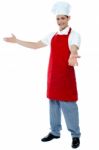 Male Chef Giving Welcome Gesture Stock Photo