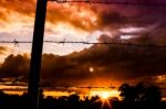 Barbed Wire Fence at Sunset Stock Photo