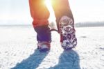 View Of Walking On Snow With Snow Shoes And Shoe Spikes In Winte Stock Photo