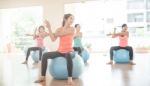 Asian Woman Doing Yoga Indoors Stock Photo