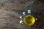 Chamomile Tea And Chamomile Flower On Old Wooden Table Stock Photo