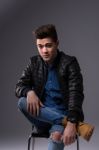 Casual Young Man In Black Leather Jacket And Denim Jeans Stock Photo