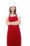 Young Female Chef With Folded Arms Stock Photo