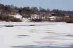 Snow Laying On The Ice At Weir Wood Reservoir Stock Photo