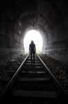 Man In A Tunnel Looking Towards The Light Stock Photo