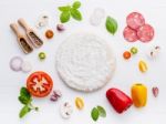 The Ingredients For Homemade Pizza On White Wooden Background Stock Photo