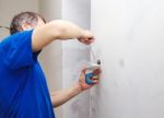 Elderly Man Installs A Switch In A New House Stock Photo